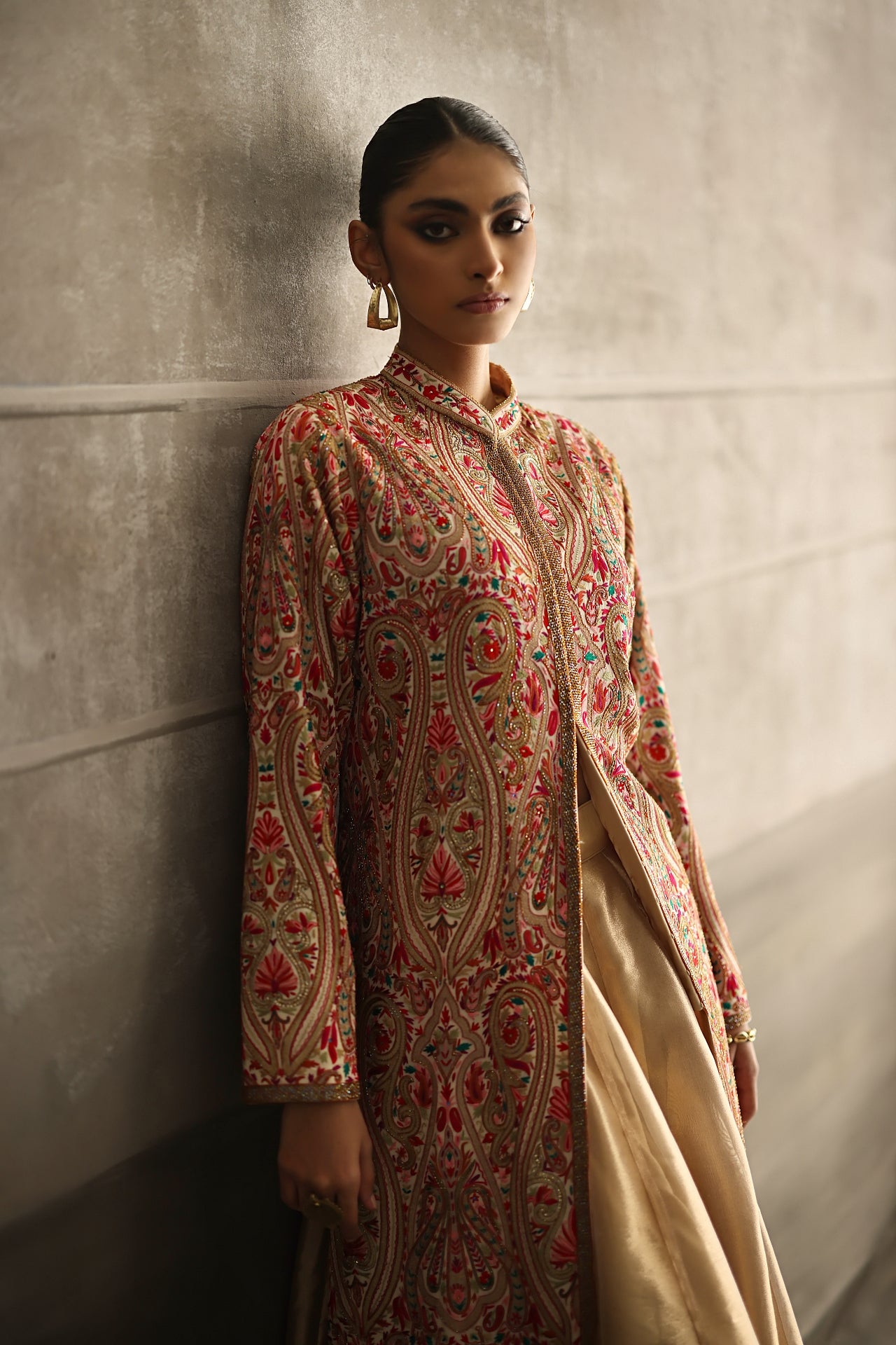 Aafrinish By Niazi Eshal Rahman Rizwan Ul Haq Gold Sequins Kashidakari Jacket Glimmering gold juxtaposed with vibrant pink and red hues make this jacket a shimmering masterpiece Pakistan Fashion